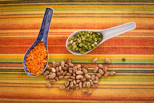 Dried Red Lentils, Split Peas, Pinto Beans in Japanese Blue and White Spoons on a Colorful Striped Mat