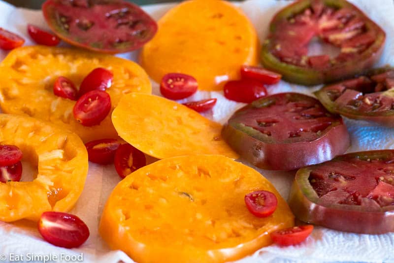 sliced yellow and red, big and small tomatoes