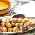Roasted Whole Baby Potatoes With Rosemary in Shallow White Serving Bowl