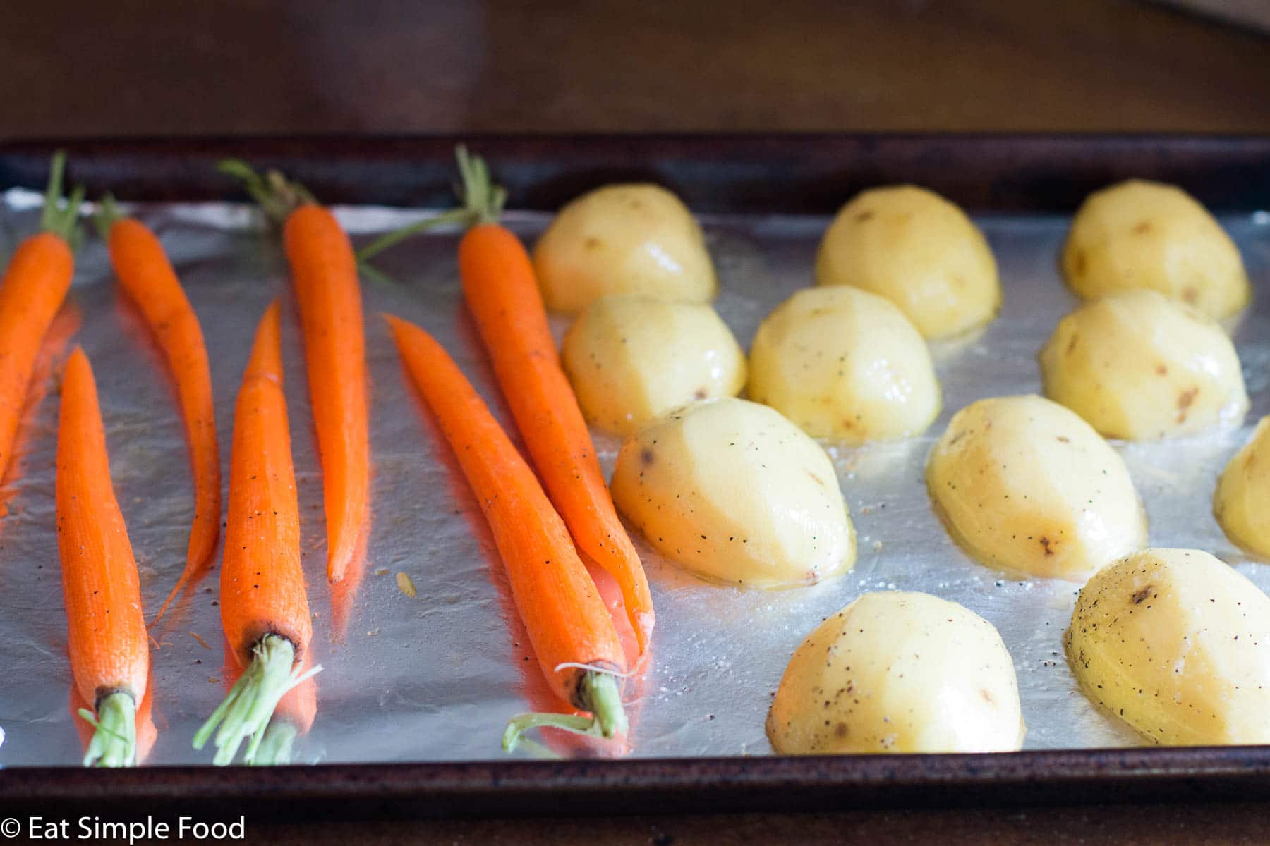 Roasted Carrots and Yukon Gold Potatoes on Sheet Pan lined with aluminum foil.