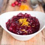 Cooked Cranberry Orange Sauce & Orange Zest Garnish in White Bowl