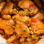 Chicken Stew with Potatoes & Sliced Green Olives In A Red Enameled Cast Iron Pot