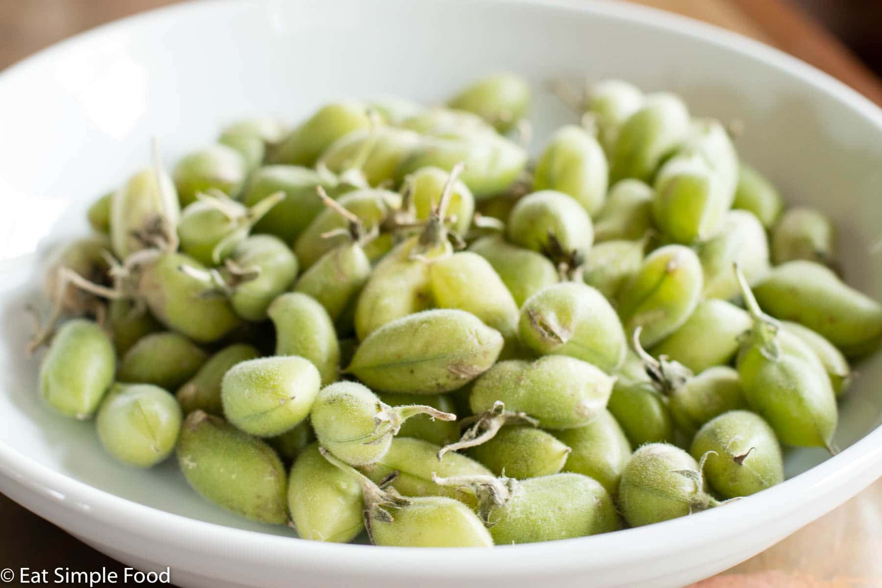Fresh Chickpeas Beans ( Green Chickpeas ) unshelled close up in a white bowl.