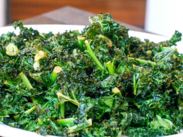 Baked Crispy Kale "Chips" On A white plate. Side View