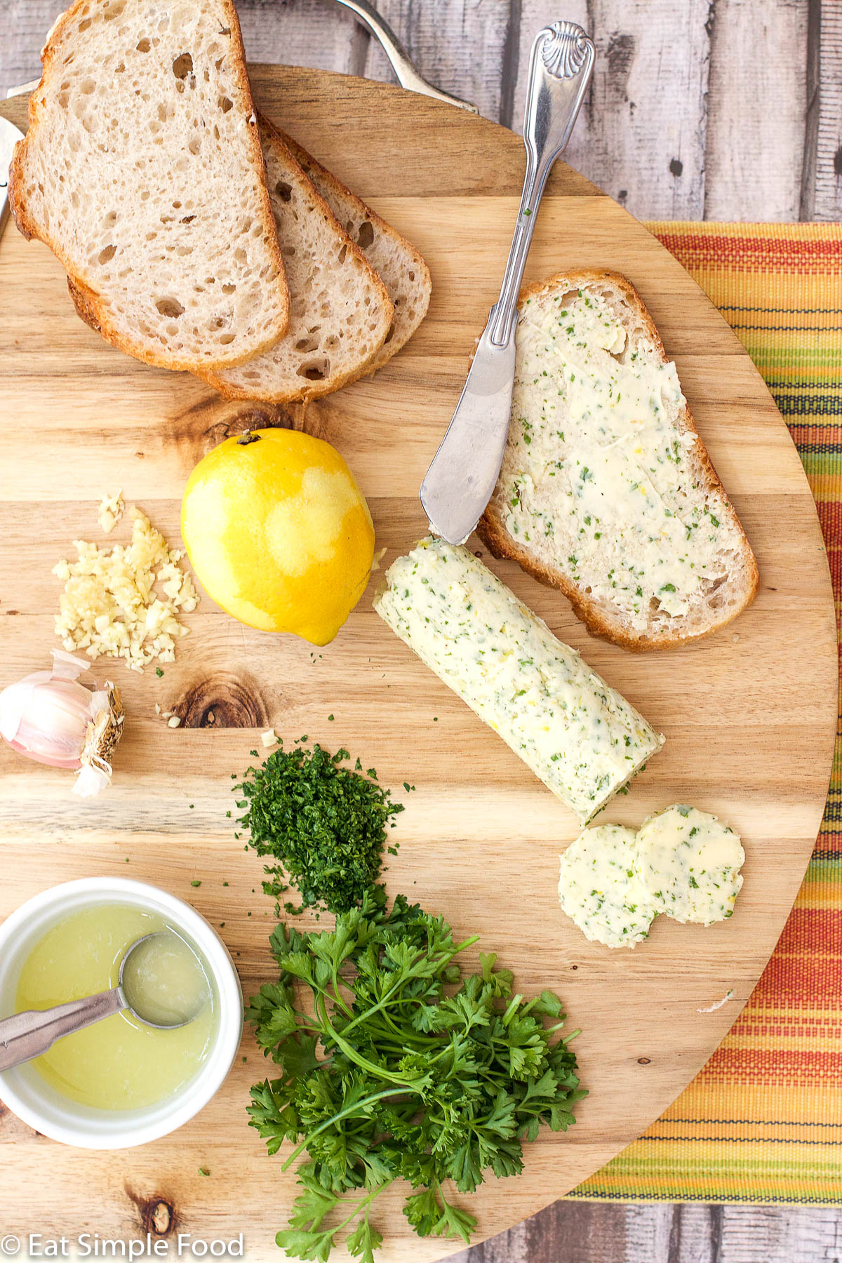Lemon Parsley Compound Butter On A Cutting Board With Ingredients