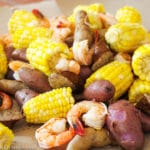 Small Potatoes, Shrimp, Sliced Andouille Sausage, Corn cooked and laid out on craft brown paper. Close up.