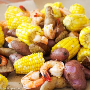Small Potatoes, Shrimp, Sliced Andouille Sausage, Corn cooked and laid out on craft brown paper. Close up.