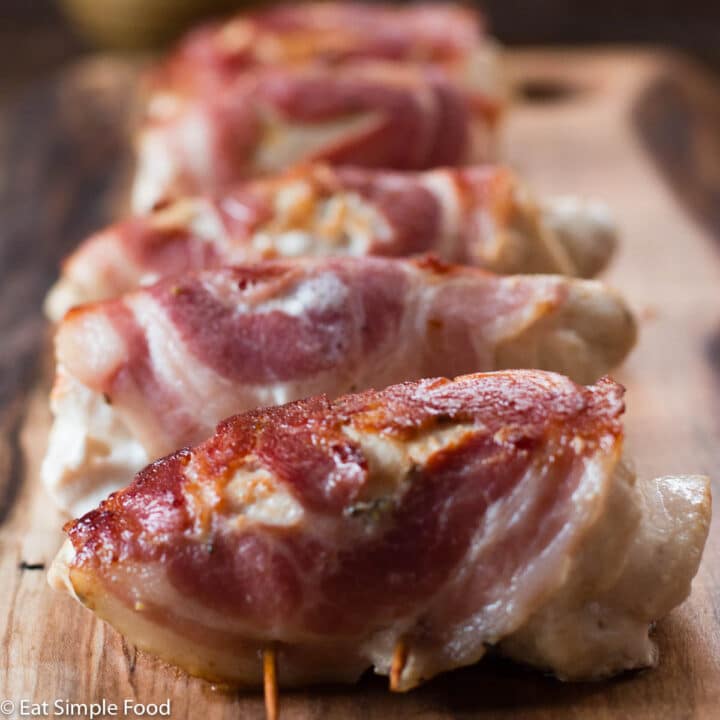 Chicken cutlets are pounded thin in this recipe with a meat mallet, filled with cooked spinach, onions, and garlic, & wrapped in pancetta and held together by toothpicks.