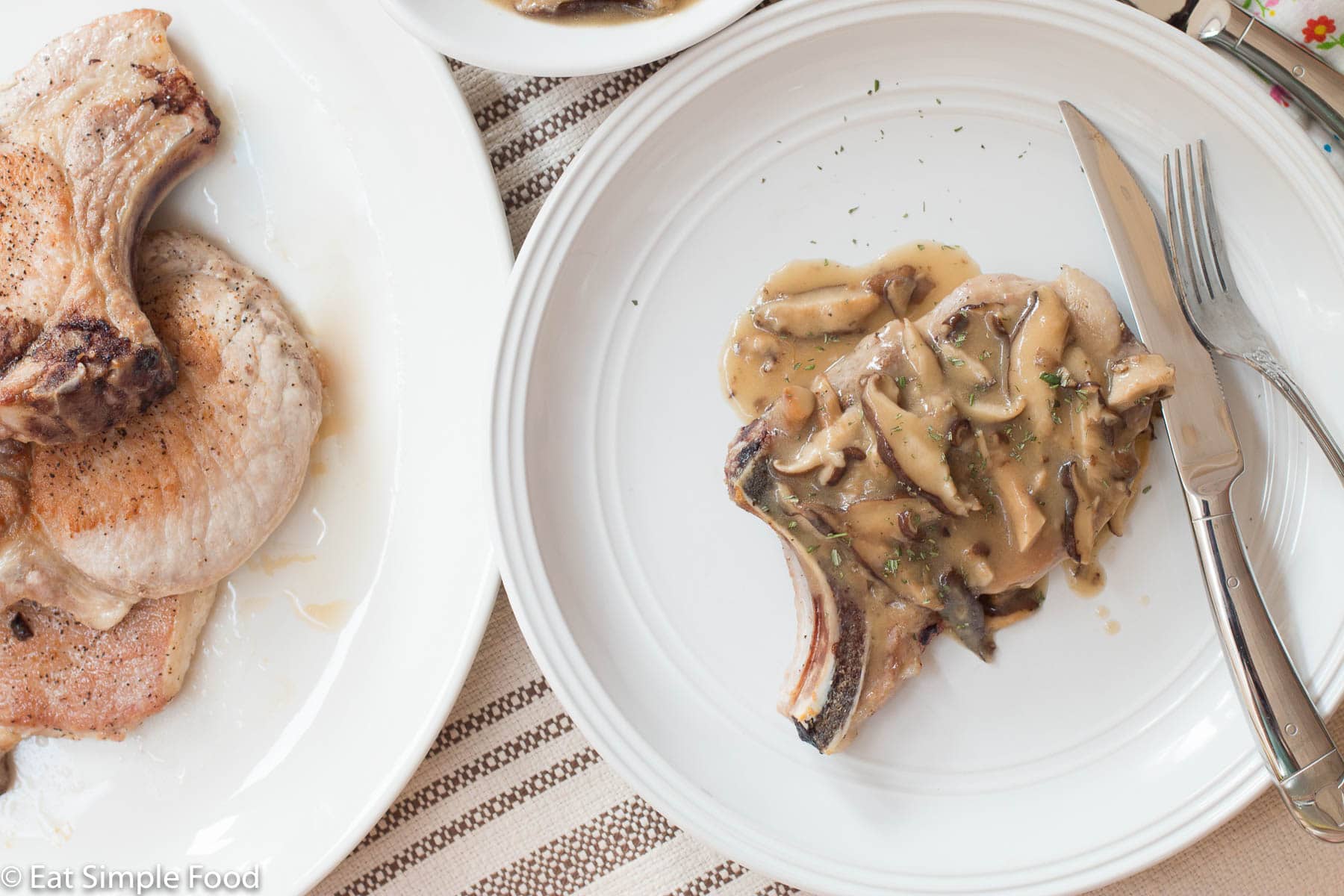 Top View of a Pork Chop on a White plate smothered with chunky mushroom gravy.