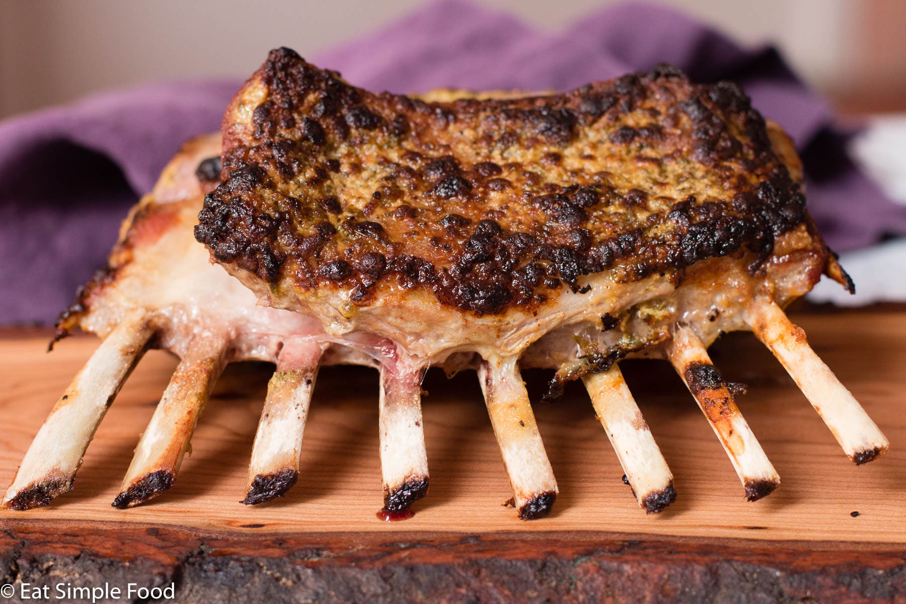 Whole Cooked Rack Of Lamb Recipe on Live Edge Wood Cutting Board