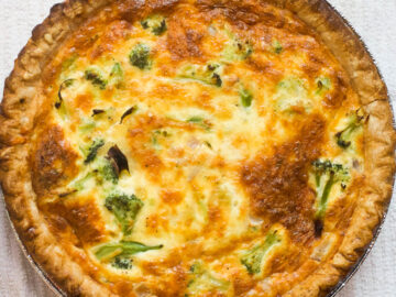 Top view of cooked Broccoli and Swiss Cheese Quiche with a browned crust.