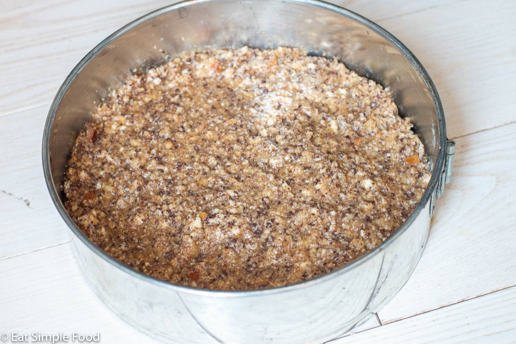 Uncooked chocolate hazelnut cake in springform pan.