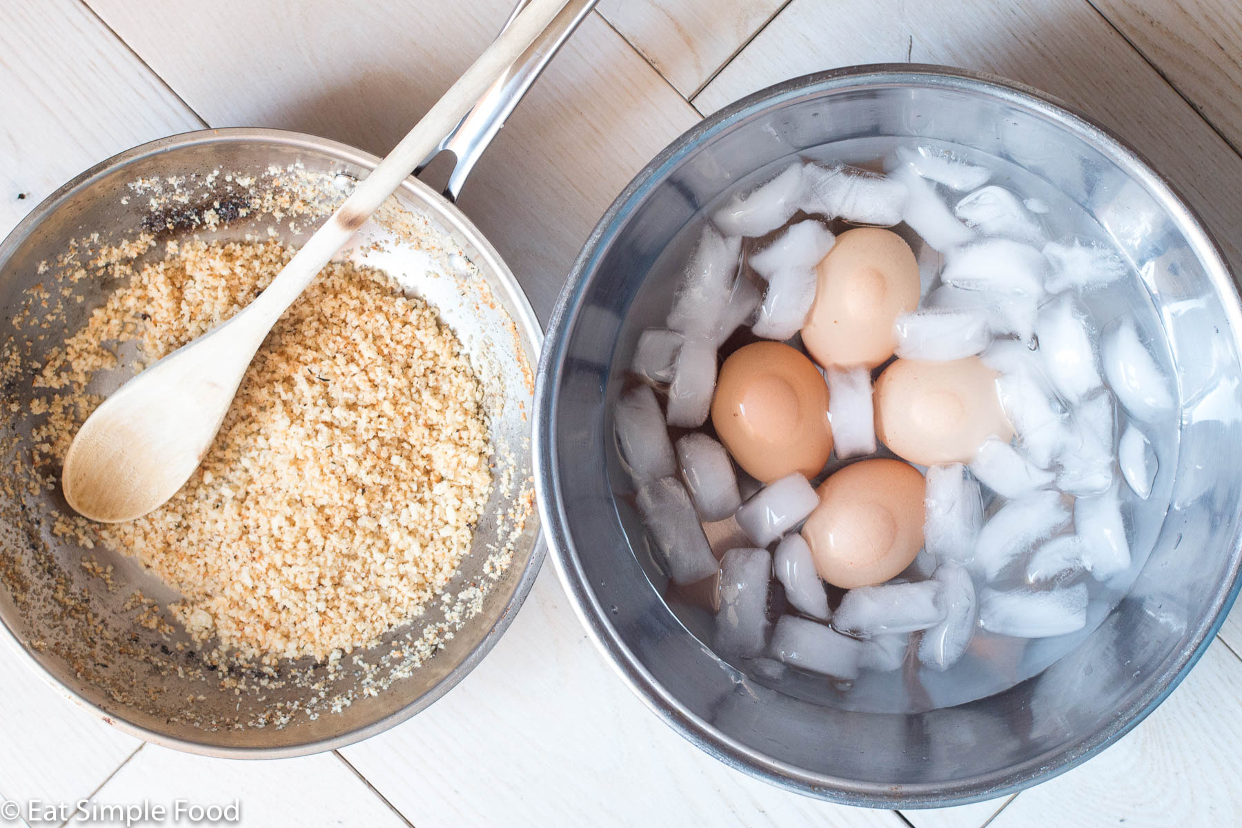 Small saucepan of lightly browned breadcrumbs and a small stainless steel bowl filled with 4 eggs and ice water.