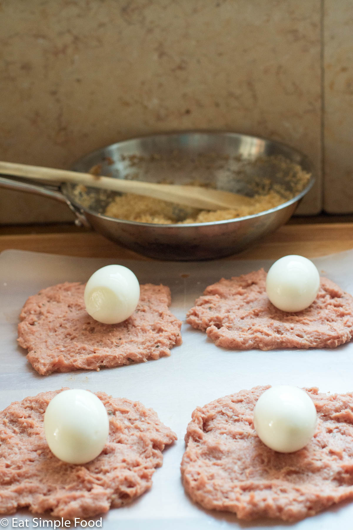 4 thin ground turkey patties with a soft boiled egg in the middle.