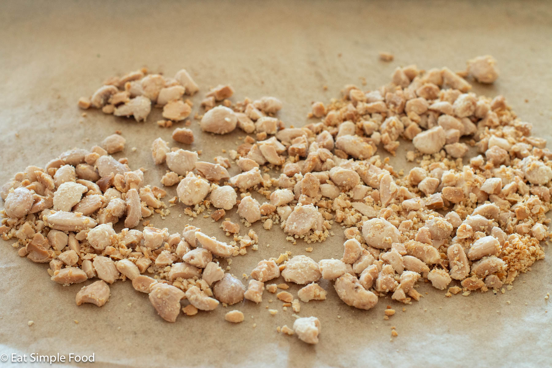 Chopped toasted almonds on parchment paper.
