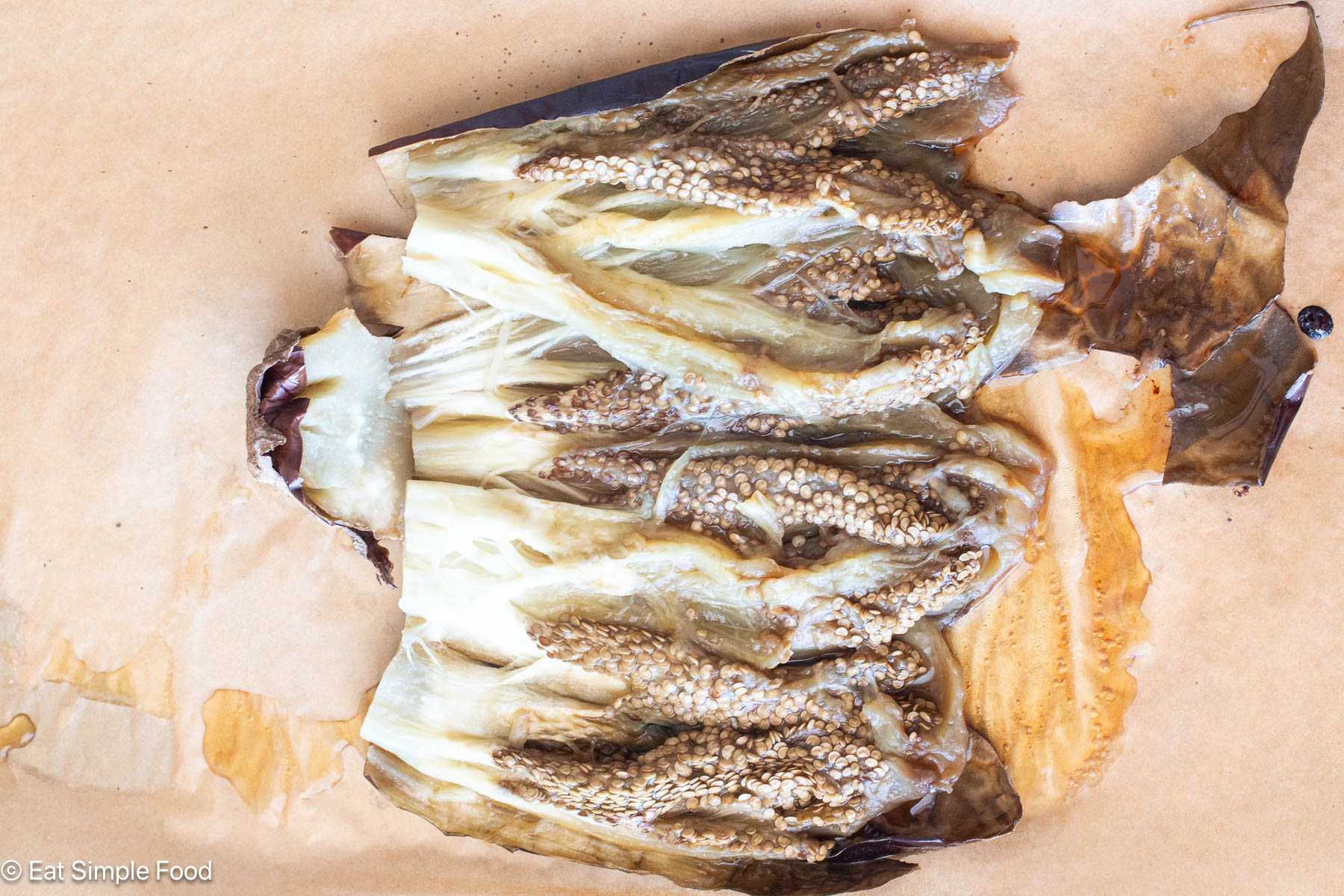 Roasted eggplant cut in half like a book.