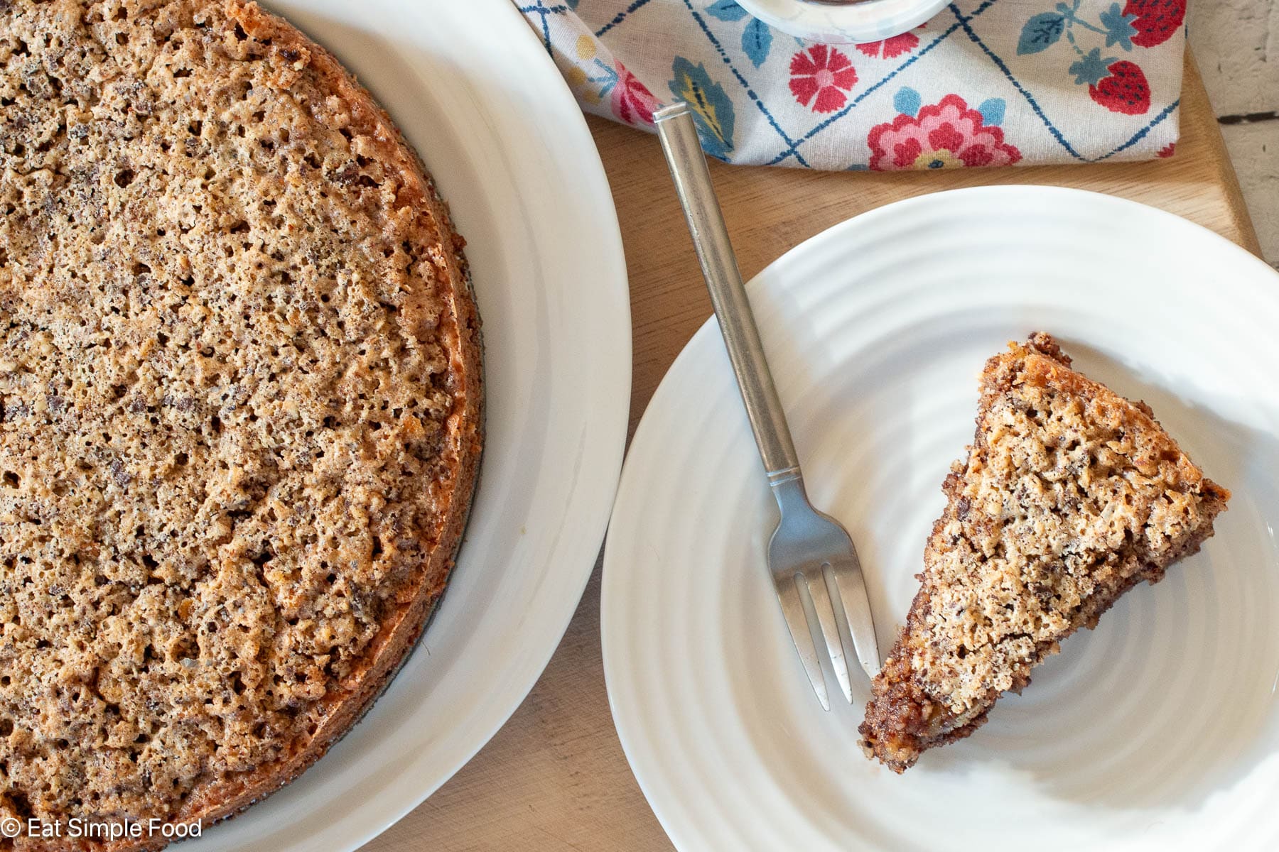 Slice of torte on a white plate with a fork. Napkin on the side. Top view. Cake on side.
