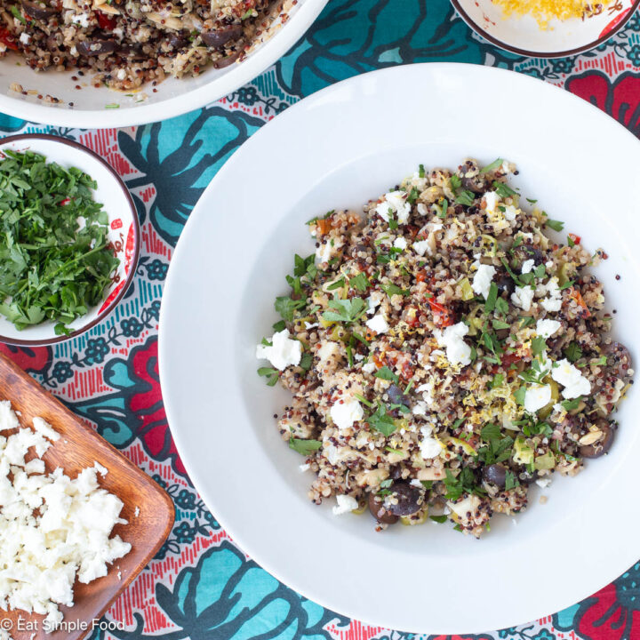 Top down view of grain salad with feta cheese on a colorful table runner.